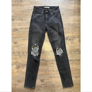 Levi’s 721 high rise skinny jeans in a faded black/gray wash with busted knees